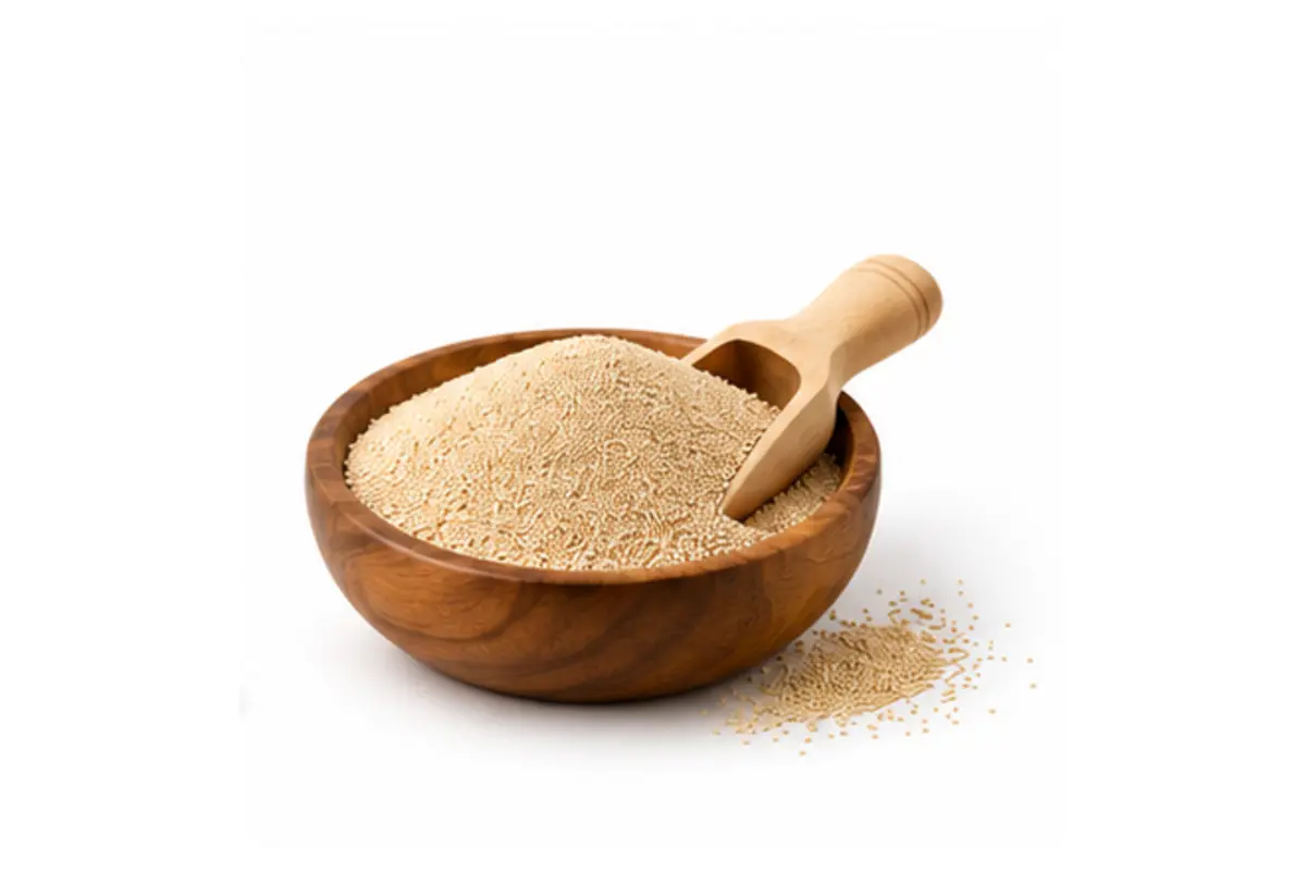 Dry yeast in a wooden bowl with scoop